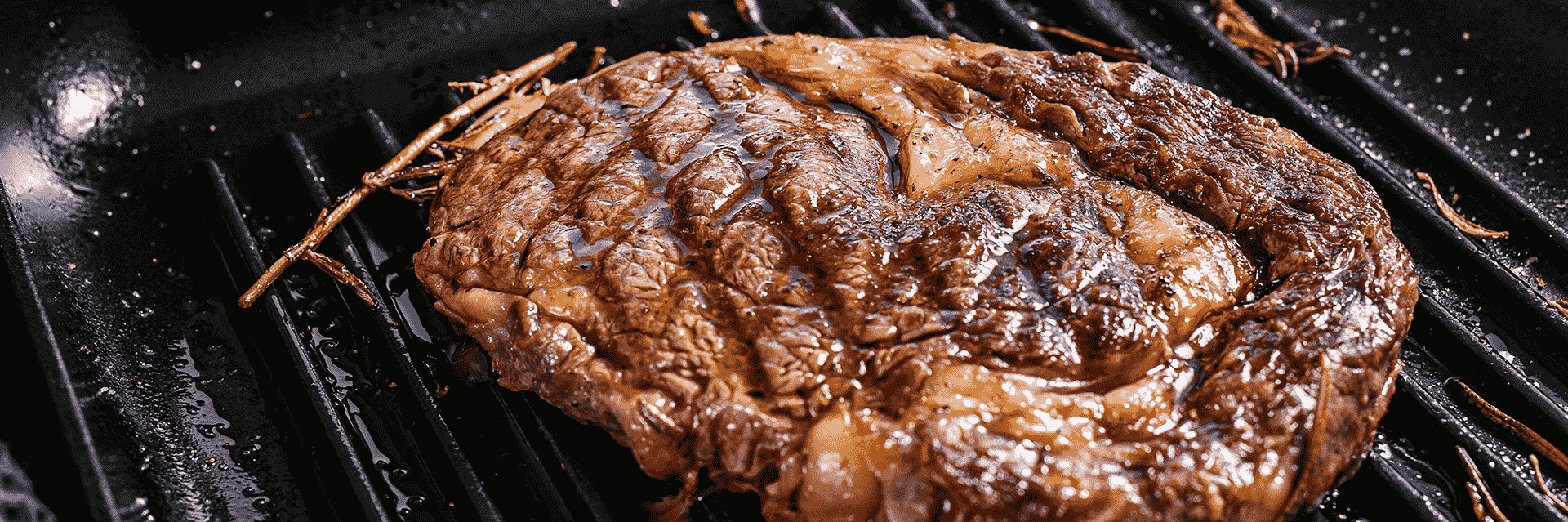 Premium Grilled Ribeye Steak | Fresh Beef | Roatan Provision Premium grilled Ribeye Steak with fresh rosemary and rich marbling available at Roatan Provision