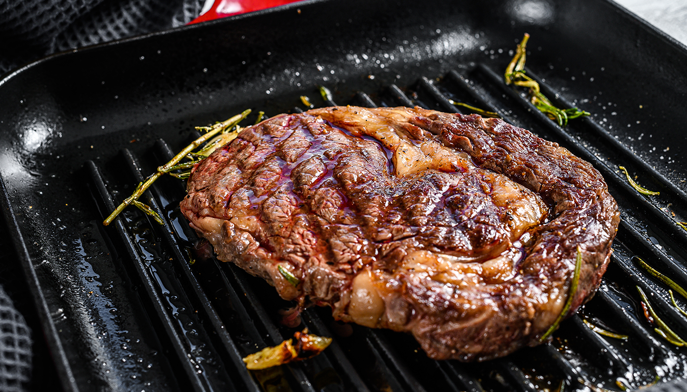 Premium Ribeye Steak grilled to perfection with fresh rosemary