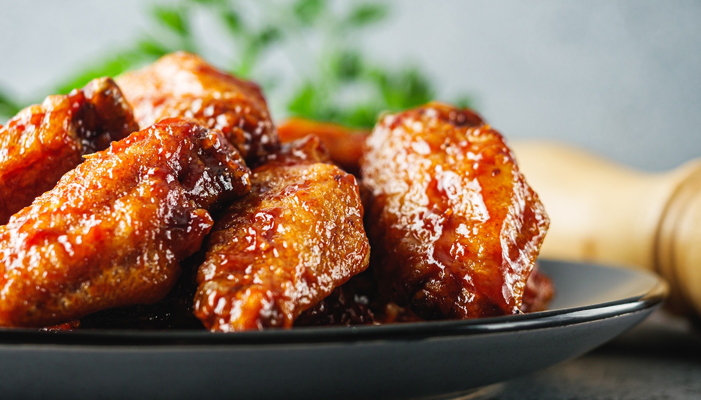 BBQ chicken wings coated in smoky barbecue sauce